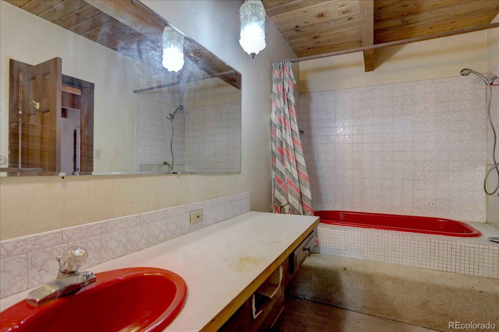 1999 Roland Drive Bailey, CO 80421 - Photo 31 of 33 a bathroom with a sink and a mirror