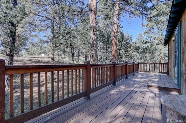 a balcony with wooden floor and fence