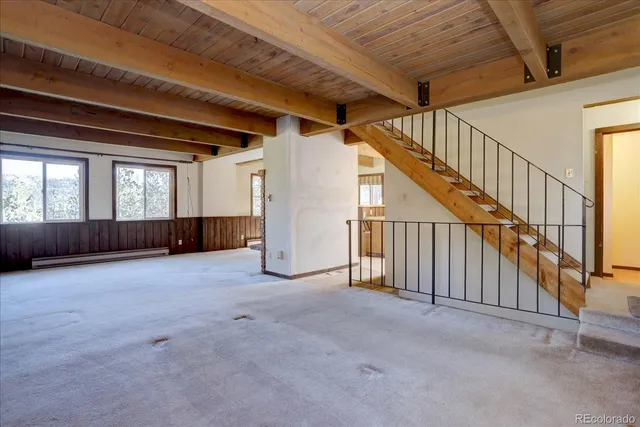 a view of an empty room with stairs