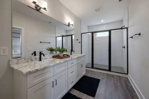 a bathroom with a double vanity sink and a mirror