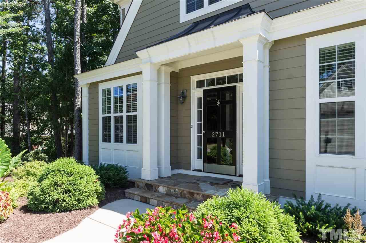 2711 Bembridge Drive Raleigh, NC 27613 - Photo 2 of 25 front view of a house with a potted plant and floor to ceiling windows