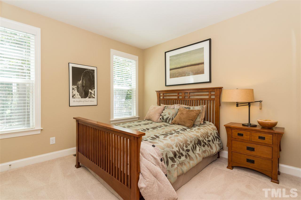 2711 Bembridge Drive Raleigh, NC 27613 - Photo 11 of 25 a bedroom with a bed and a lamp on dresser