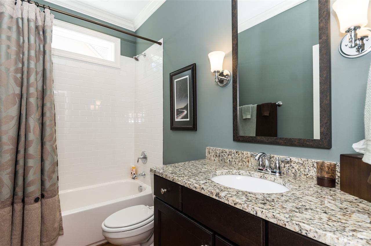 2711 Bembridge Drive Raleigh, NC 27613 - Photo 12 of 25 a bathroom with a granite countertop sink toilet and shower