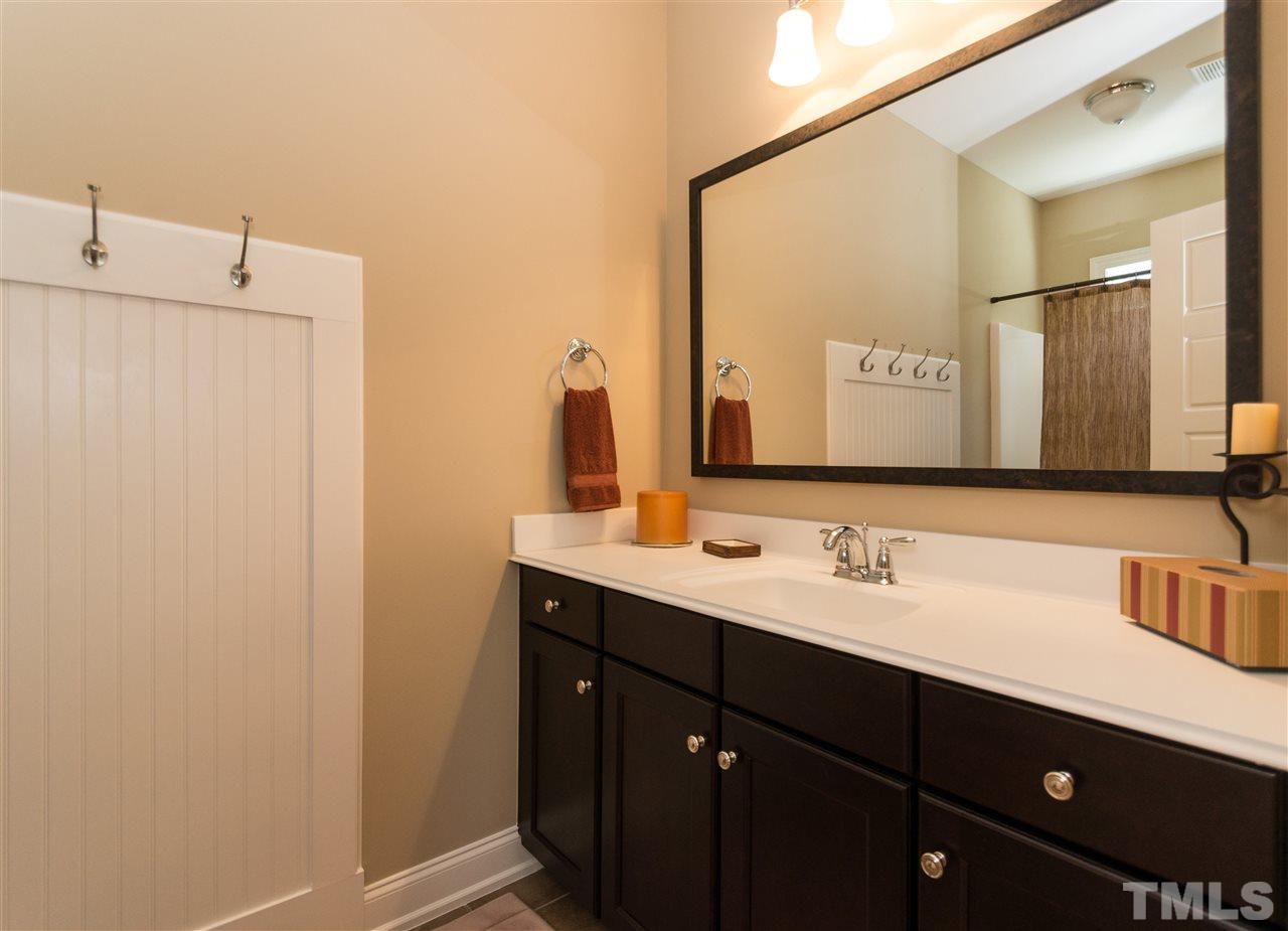 2711 Bembridge Drive Raleigh, NC 27613 - Photo 18 of 25 a bathroom with a double vanity sink and mirror