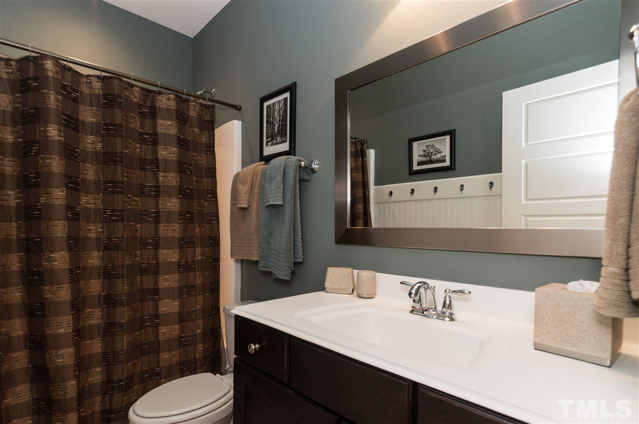 2711 Bembridge Drive Raleigh, NC 27613 - Photo 20 of 25 a bathroom with a sink toilet vanity and shower
