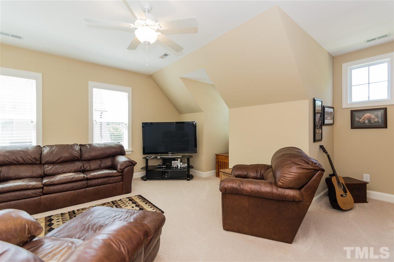 2711 Bembridge Drive Raleigh, NC 27613 - Photo 21 of 25 a living room with furniture and a flat screen tv