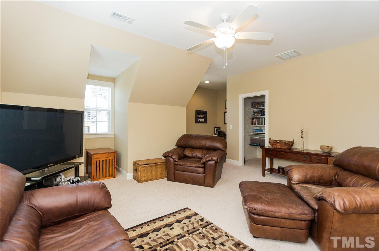 2711 Bembridge Drive Raleigh, NC 27613 - Photo 22 of 25 a living room with furniture and a flat screen tv