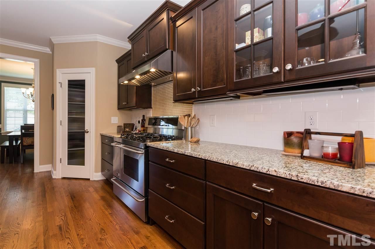 2711 Bembridge Drive Raleigh, NC 27613 - Photo 8 of 25 a kitchen with granite countertop stainless steel appliances a sink and cabinets