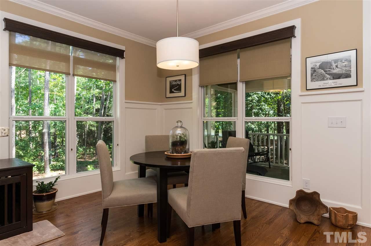 2711 Bembridge Drive Raleigh, NC 27613 - Photo 10 of 25 a dining room with furniture a chandelier and wooden floor