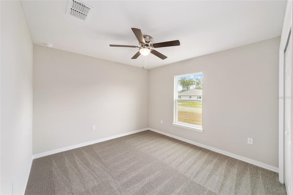 7866 North Manville Road Citrus Springs, FL 34434 - Photo 10 of 19 an empty room with window and ceiling fan