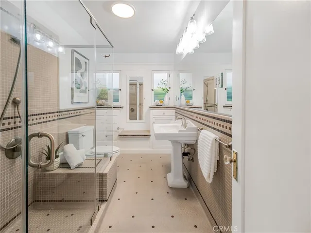 a living room with furniture a fireplace and a chandelier