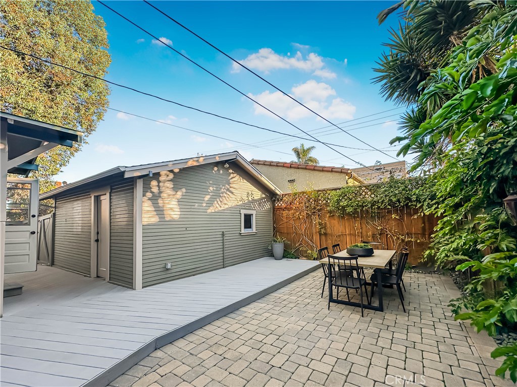 3740 East 5th Street Long Beach, CA 90814 - Photo 21 of 28 a view of a patio with table and chairs and potted plants