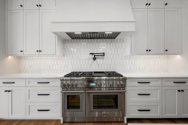 a stove top oven sitting inside of a kitchen