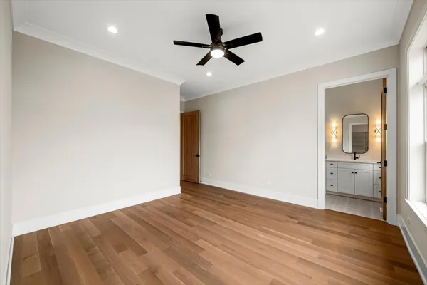 a view of empty room with wooden floor