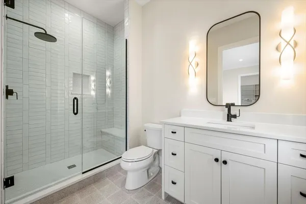 a bathroom with a toilet sink and shower