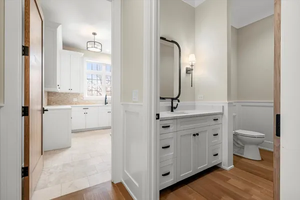 a bathroom with a toilet a sink and mirror