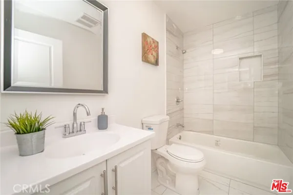 a bathroom with a sink a toilet and a bathtub