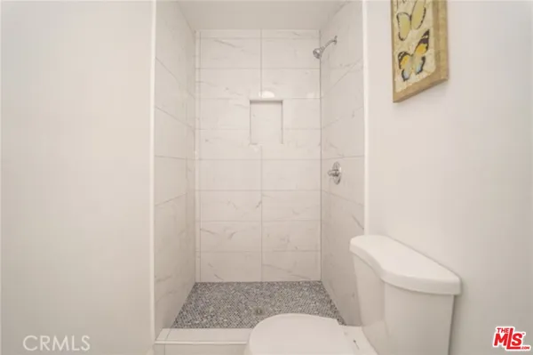 a bathroom with a toilet and a shower