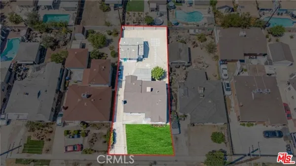 an aerial view of residential houses with outdoor space