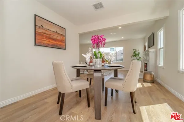 a dining room with furniture and wooden floor