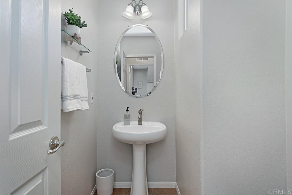5595 Foxtail Loop Carlsbad, CA 92010 - Photo 14 of 28 a bathroom with a sink a mirror and a toilet