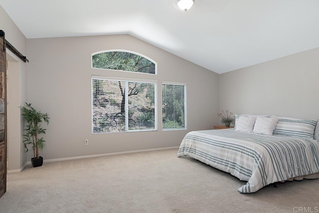 5595 Foxtail Loop Carlsbad, CA 92010 - Photo 18 of 28 a bedroom with a bed and a window