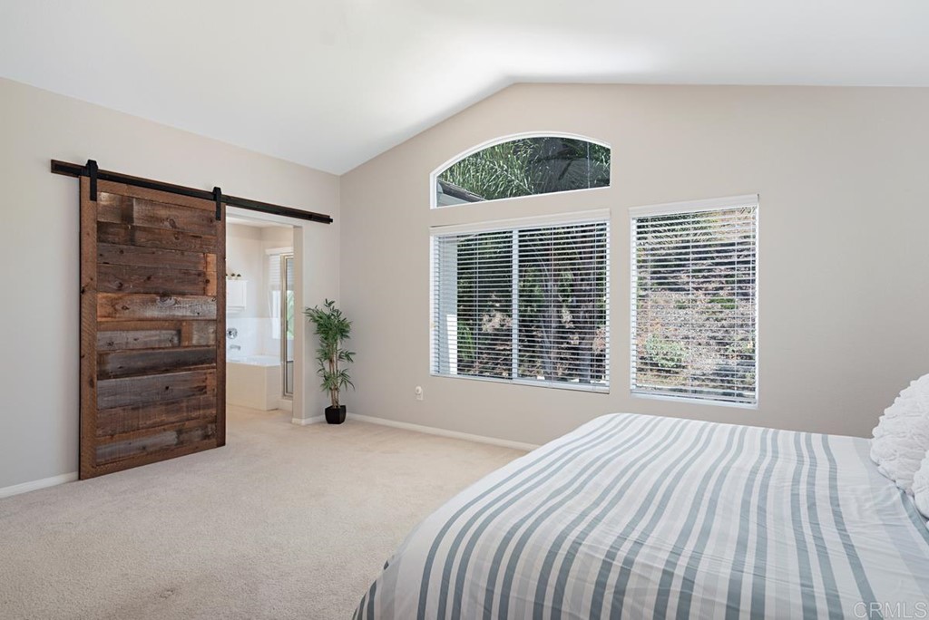 5595 Foxtail Loop Carlsbad, CA 92010 - Photo 19 of 28 a view of a bedroom with furniture and windows