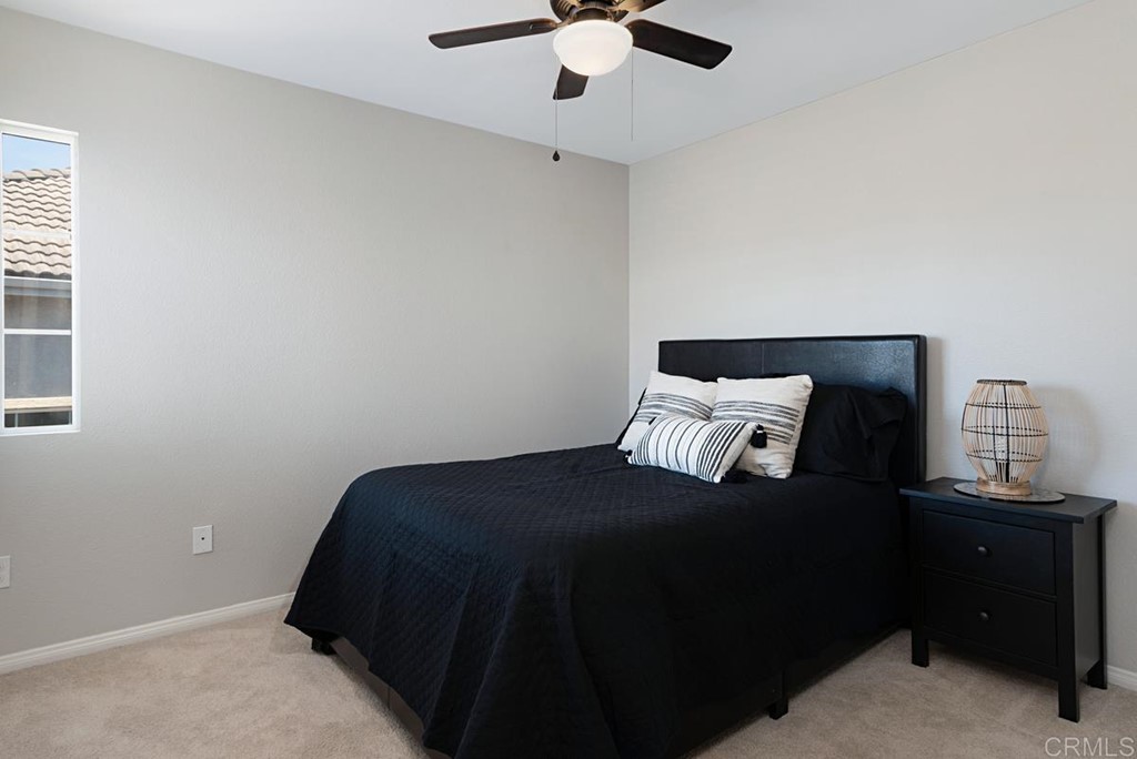 5595 Foxtail Loop Carlsbad, CA 92010 - Photo 21 of 28 a bedroom with a bed and a window