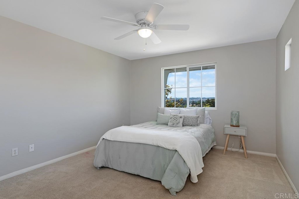 5595 Foxtail Loop Carlsbad, CA 92010 - Photo 23 of 28 a bedroom with a bed and a window