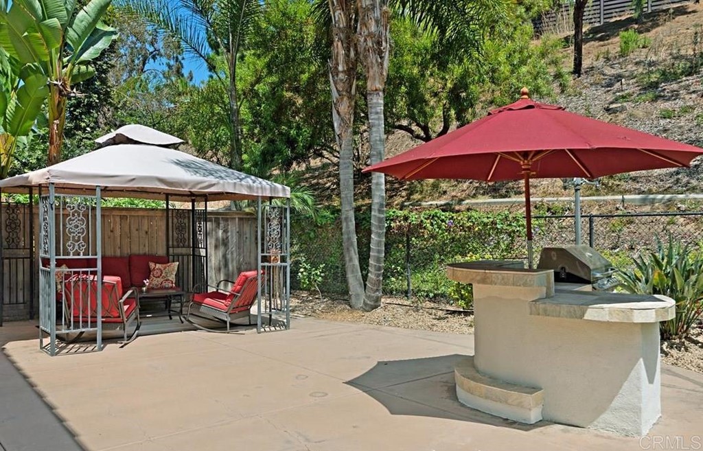 5595 Foxtail Loop Carlsbad, CA 92010 - Photo 27 of 28 a view of a patio with furniture and umbrella