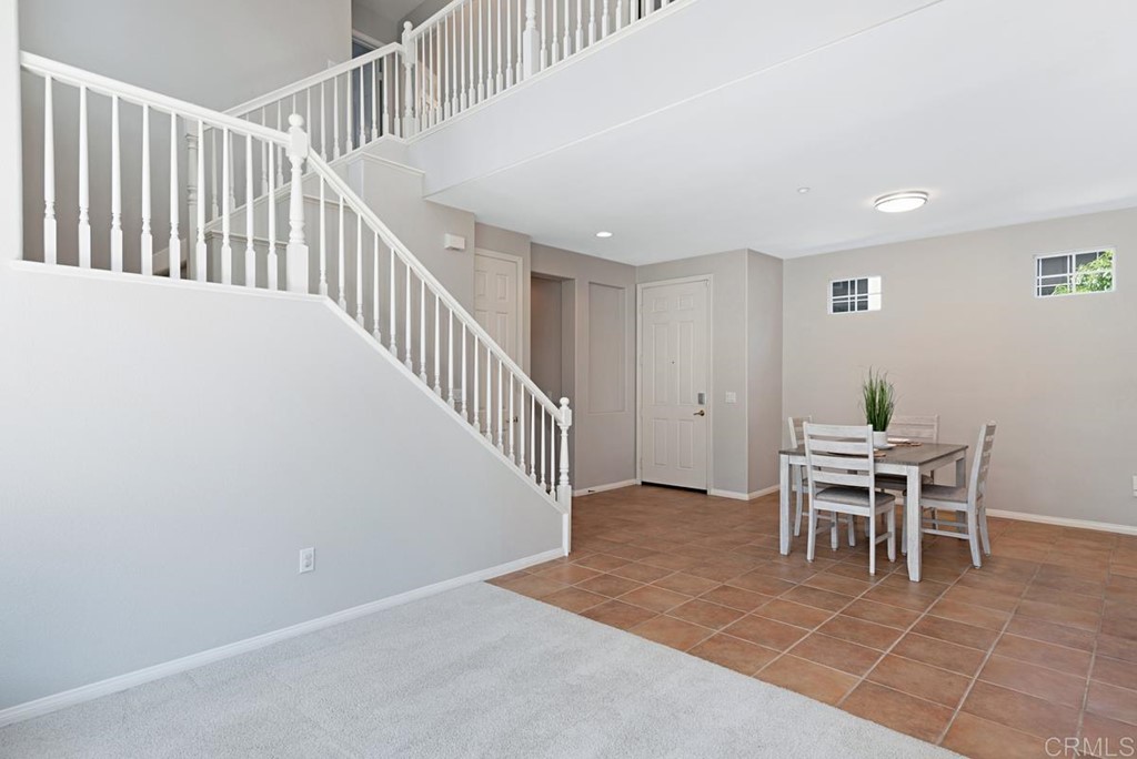 5595 Foxtail Loop Carlsbad, CA 92010 - Photo 3 of 28 a dining room with furniture and a dining table with chairs