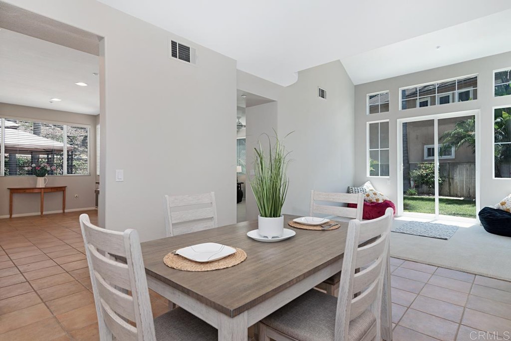 5595 Foxtail Loop Carlsbad, CA 92010 - Photo 5 of 28 a view of a dining room with furniture and a potted plant