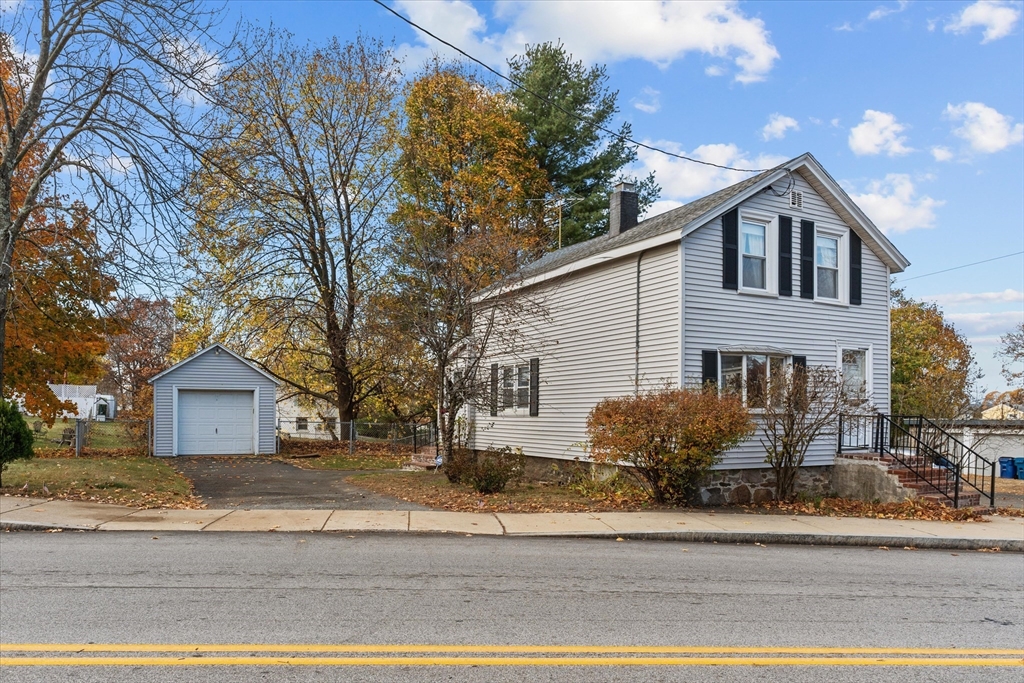 79 Beacon Street Lawrence, MA 01843 - Photo 1 of 29 a front view of house with garage and yard