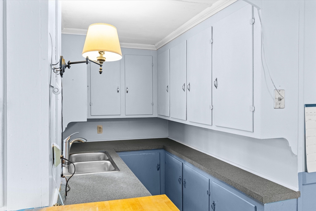 79 Beacon Street Lawrence, MA 01843 - Photo 11 of 29 a kitchen with a sink and a stove top oven
