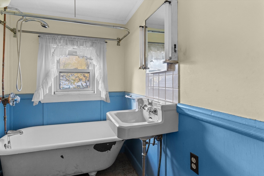 79 Beacon Street Lawrence, MA 01843 - Photo 12 of 29 a bathroom with a sink a bath tub and a shower