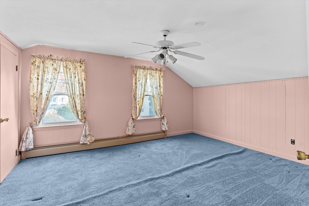79 Beacon Street Lawrence, MA 01843 - Photo 19 of 29 an empty room with chandelier fan and windows