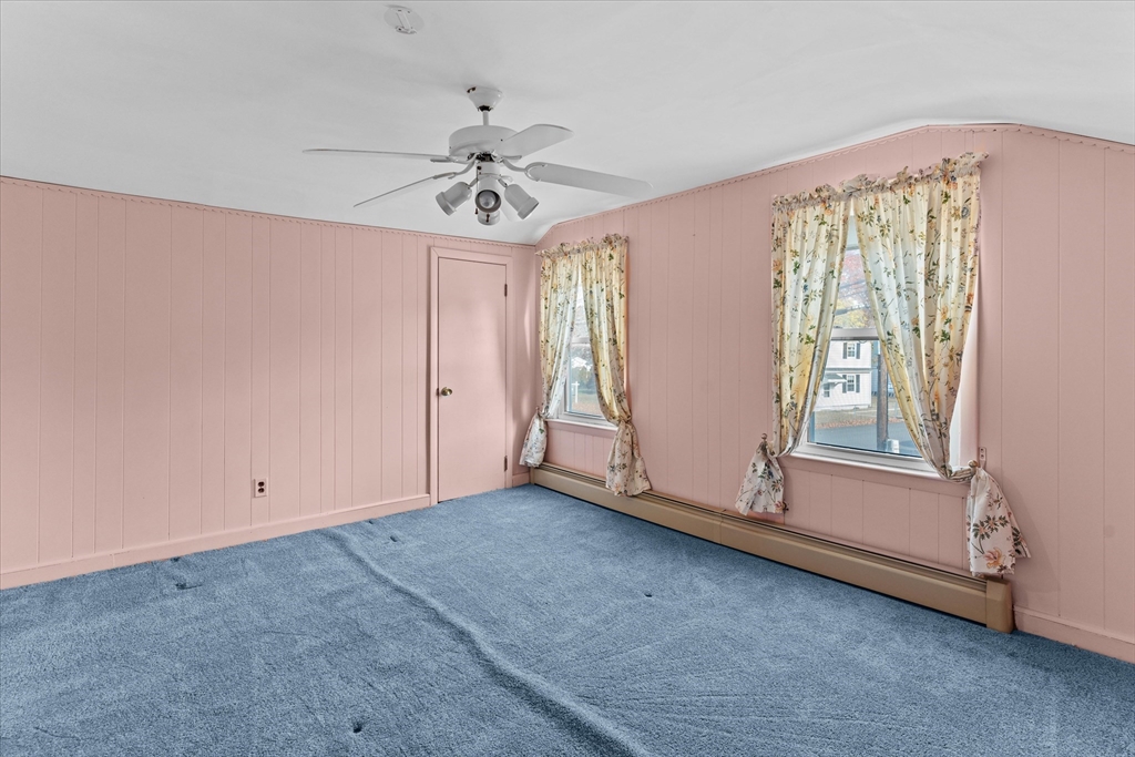 79 Beacon Street Lawrence, MA 01843 - Photo 20 of 29 an empty room with chandelier fan and windows