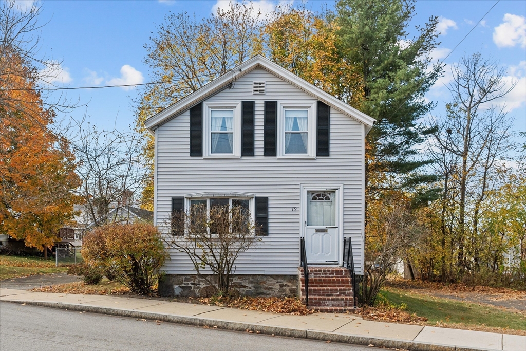 79 Beacon Street Lawrence, MA 01843 - Photo 2 of 29 a front view of a house with a yard