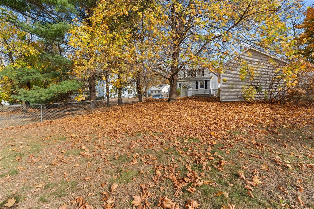 79 Beacon Street Lawrence, MA 01843 - Photo 27 of 29 a backyard of a house with large trees