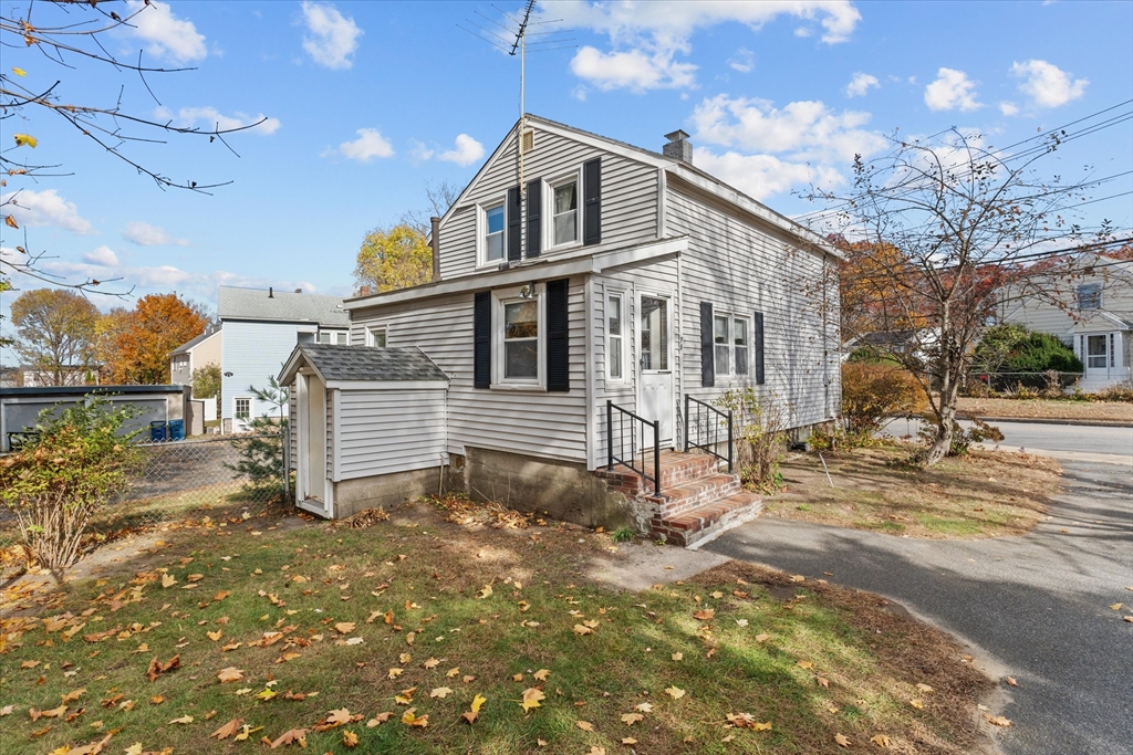 79 Beacon Street Lawrence, MA 01843 - Photo 28 of 29 a white house that has tree in front of it