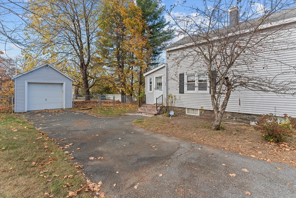 79 Beacon Street Lawrence, MA 01843 - Photo 4 of 29 a view of a house with a yard and garage