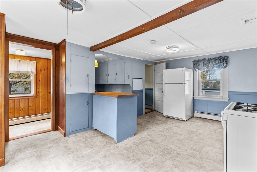 79 Beacon Street Lawrence, MA 01843 - Photo 7 of 29 a view of kitchen with refrigerator and window