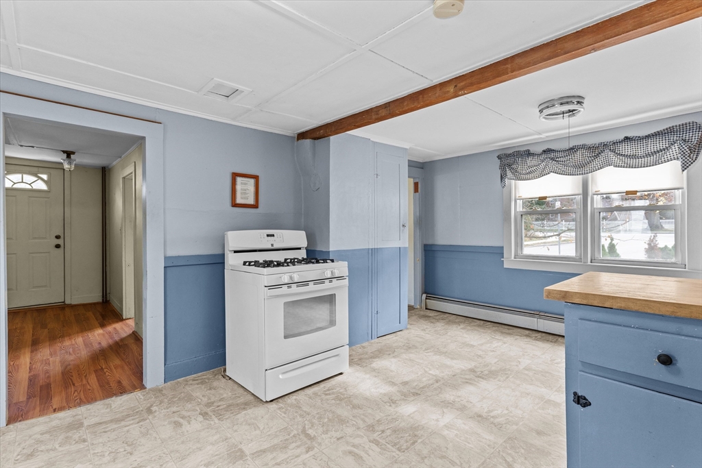 79 Beacon Street Lawrence, MA 01843 - Photo 9 of 29 a kitchen with a stove and a cabinet