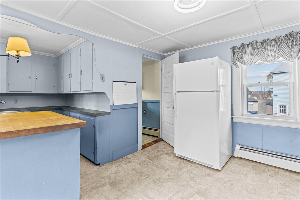 79 Beacon Street Lawrence, MA 01843 - Photo 10 of 29 a kitchen with stainless steel appliances granite countertop a refrigerator and a stove