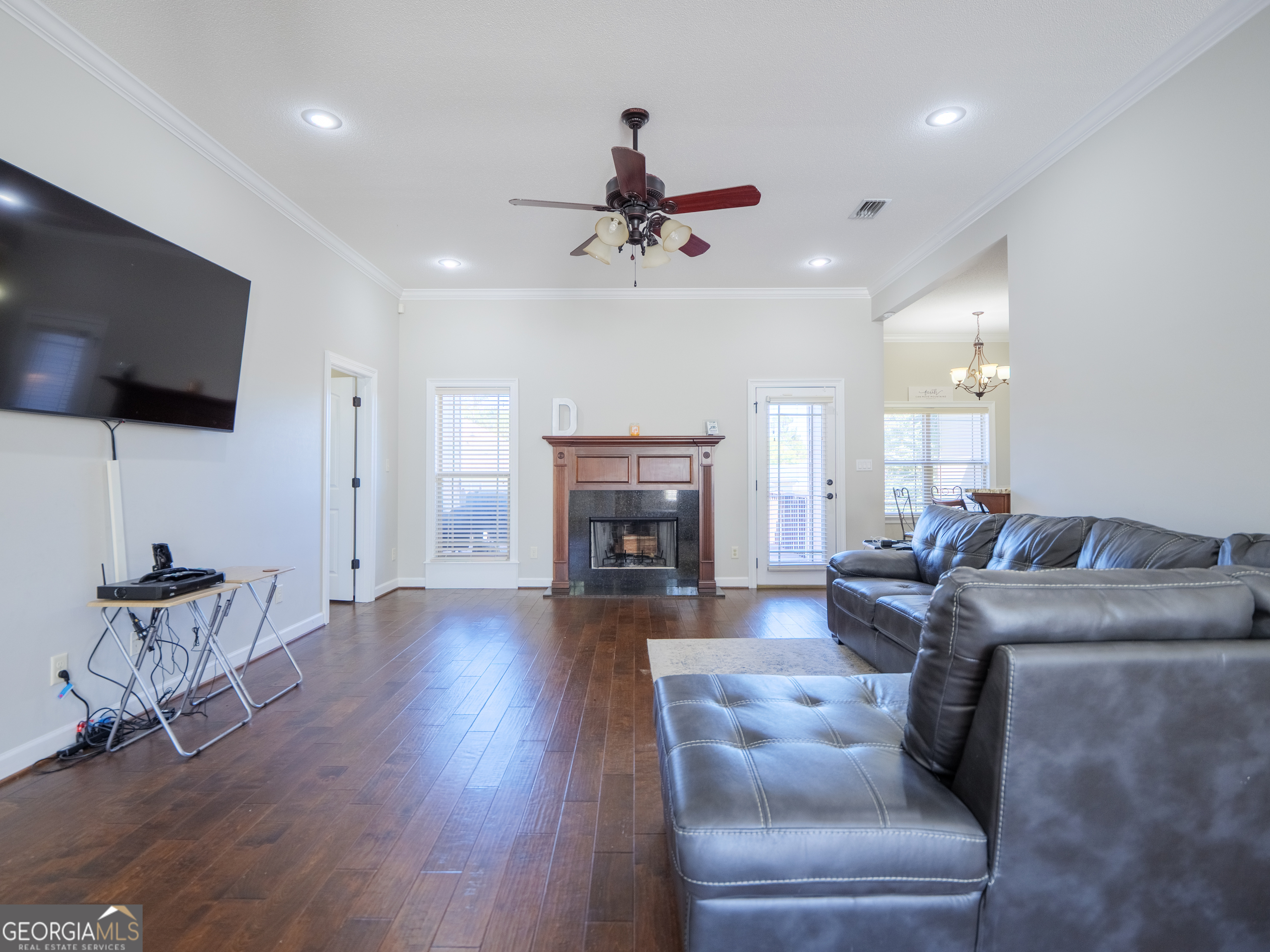 4049 Applecross Road Valdosta, GA 31605 - Photo 11 of 48 a living room with furniture a flat screen tv and a fireplace