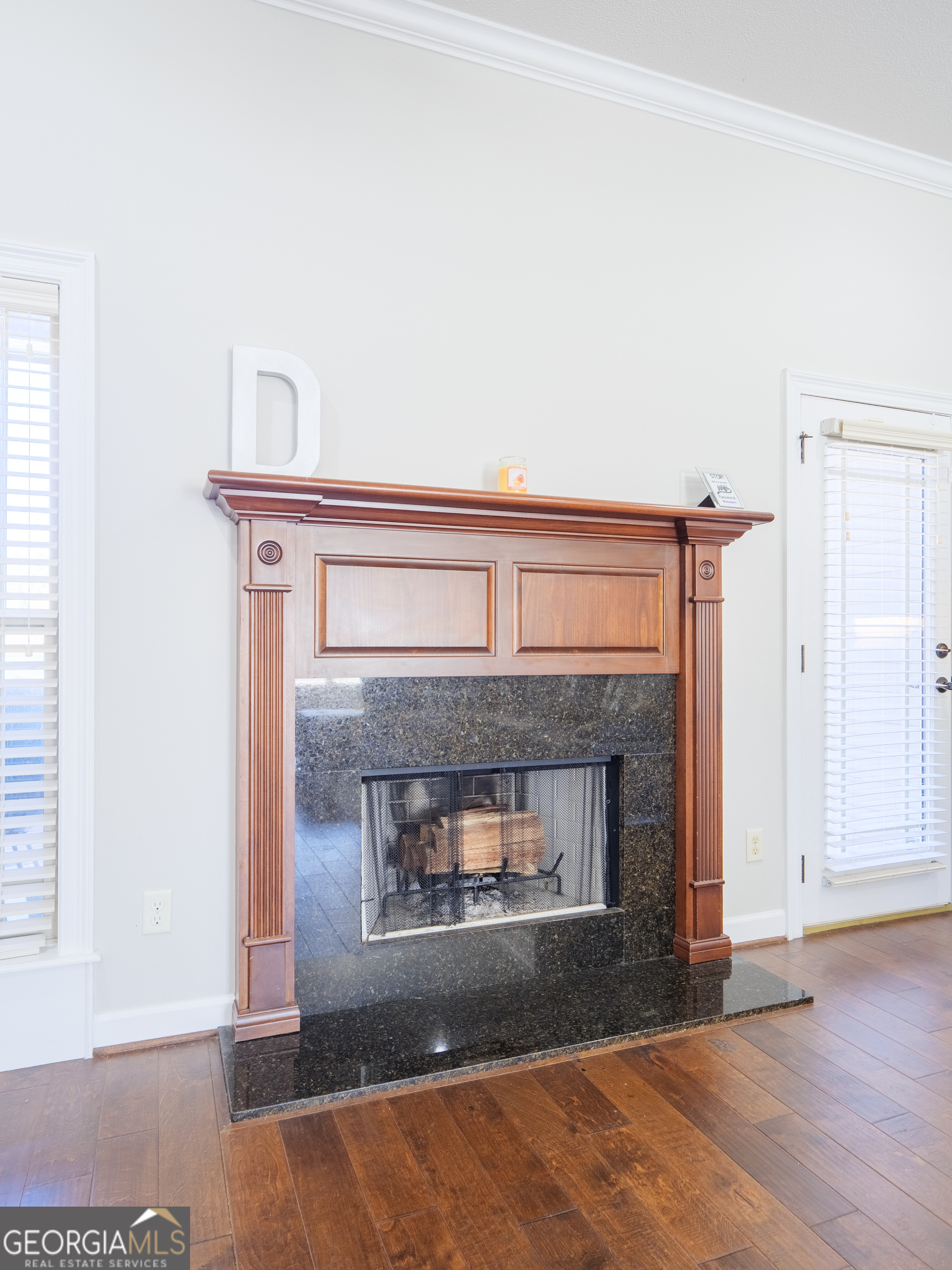 4049 Applecross Road Valdosta, GA 31605 - Photo 16 of 48 an empty room with a fireplace and wooden floor