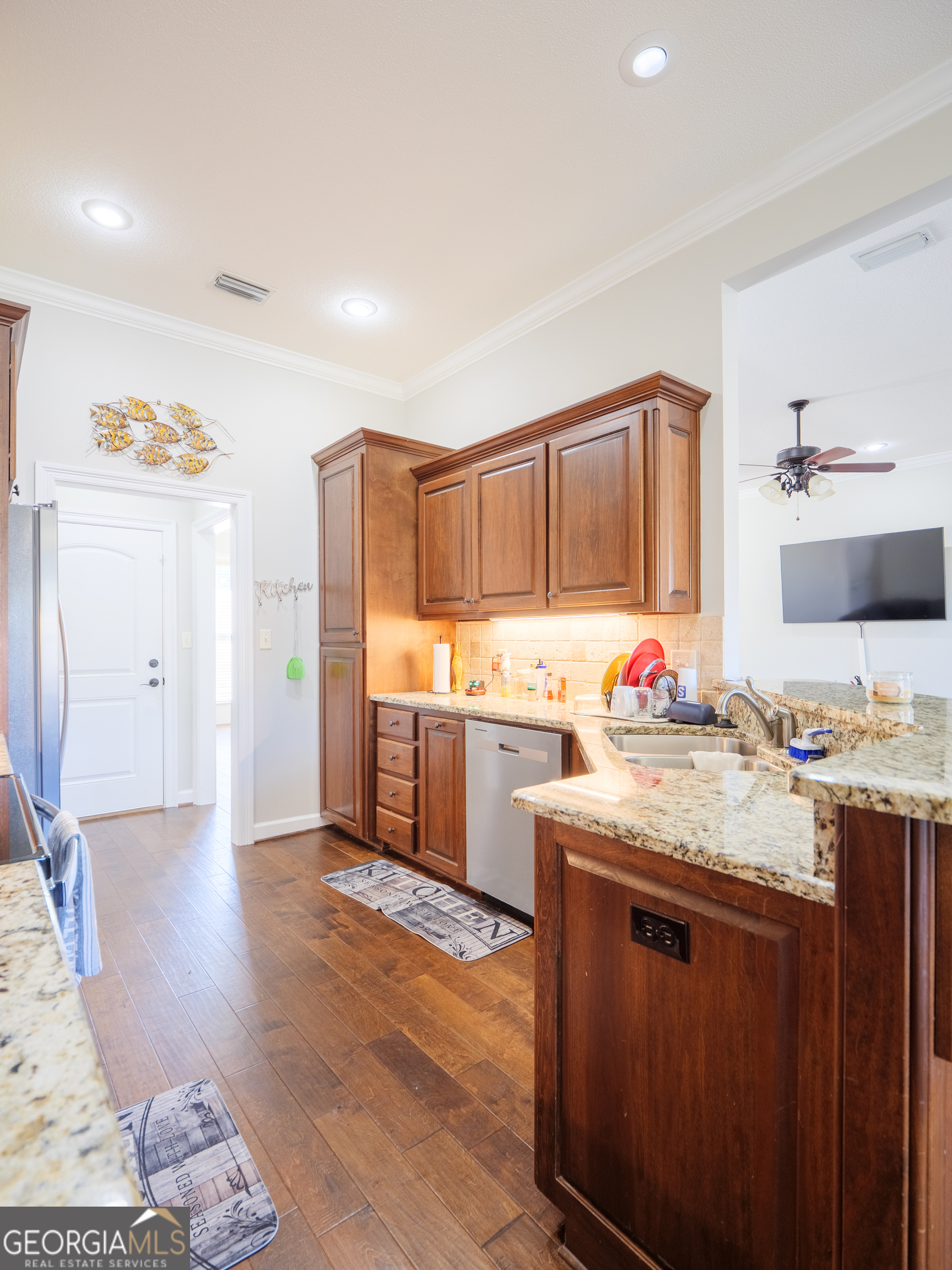4049 Applecross Road Valdosta, GA 31605 - Photo 24 of 48 a kitchen with granite countertop a sink cabinets and wooden floor