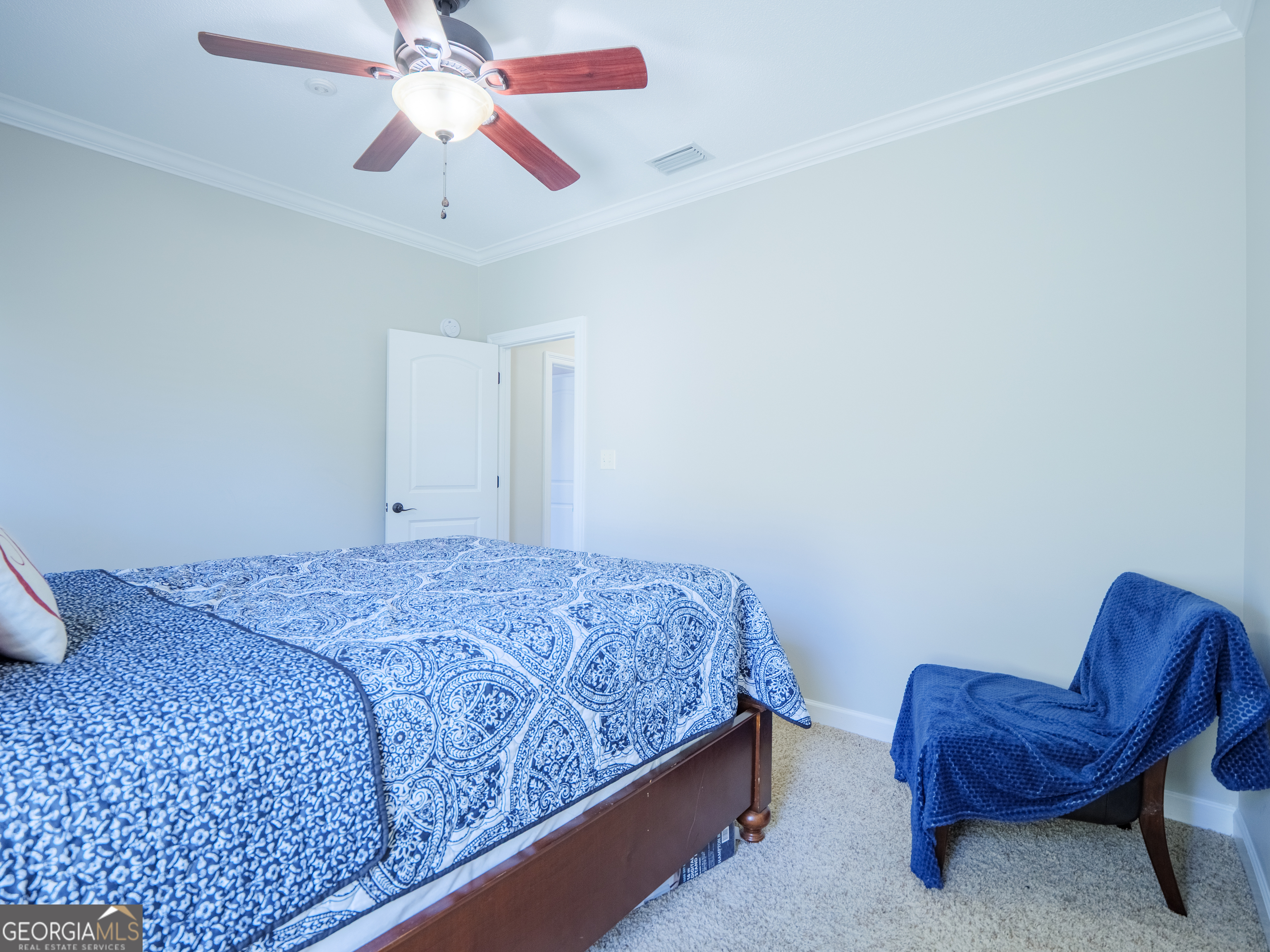 4049 Applecross Road Valdosta, GA 31605 - Photo 45 of 48 a bedroom with a bed and a chandelier fan
