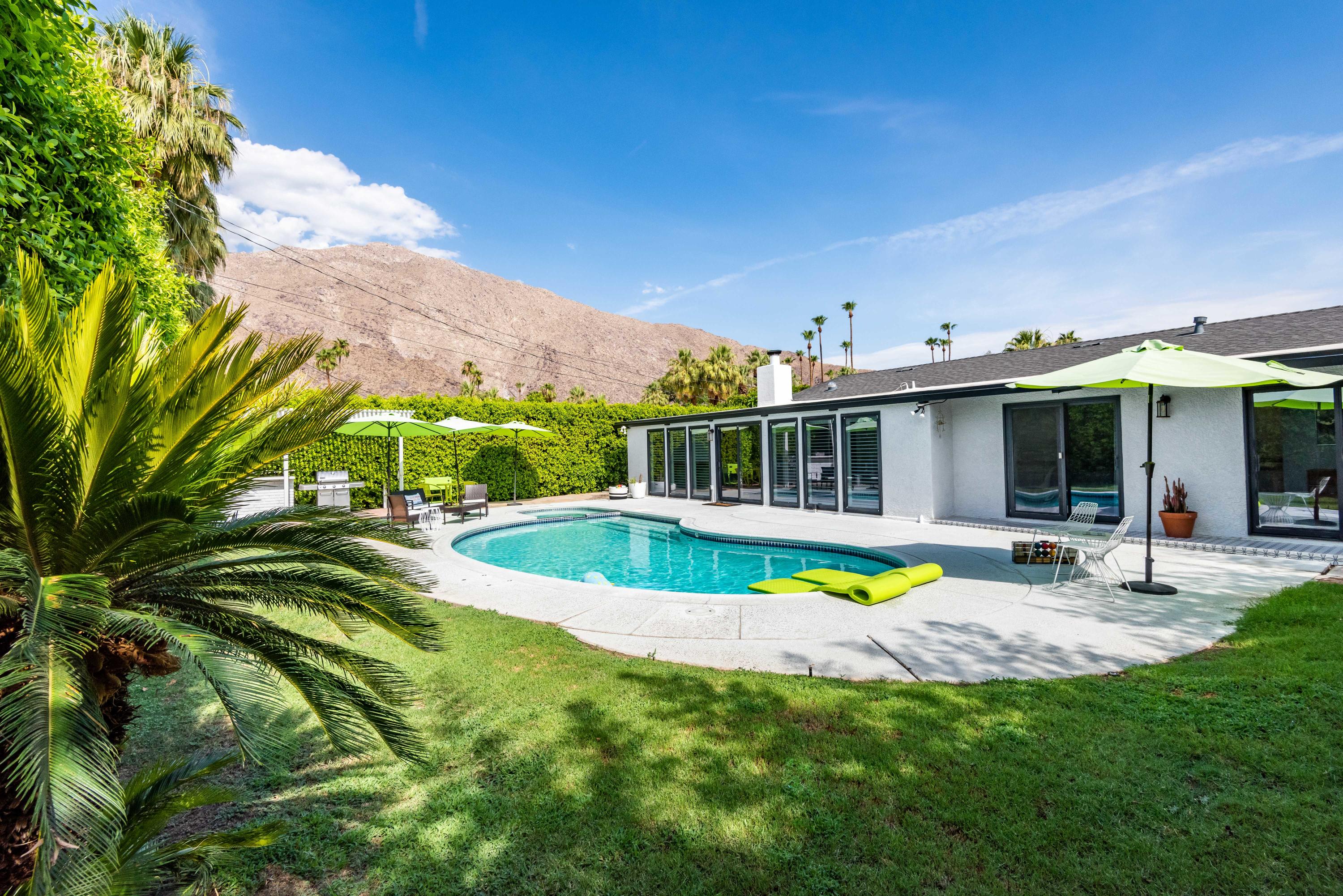 a view of a house with swimming pool and sitting area