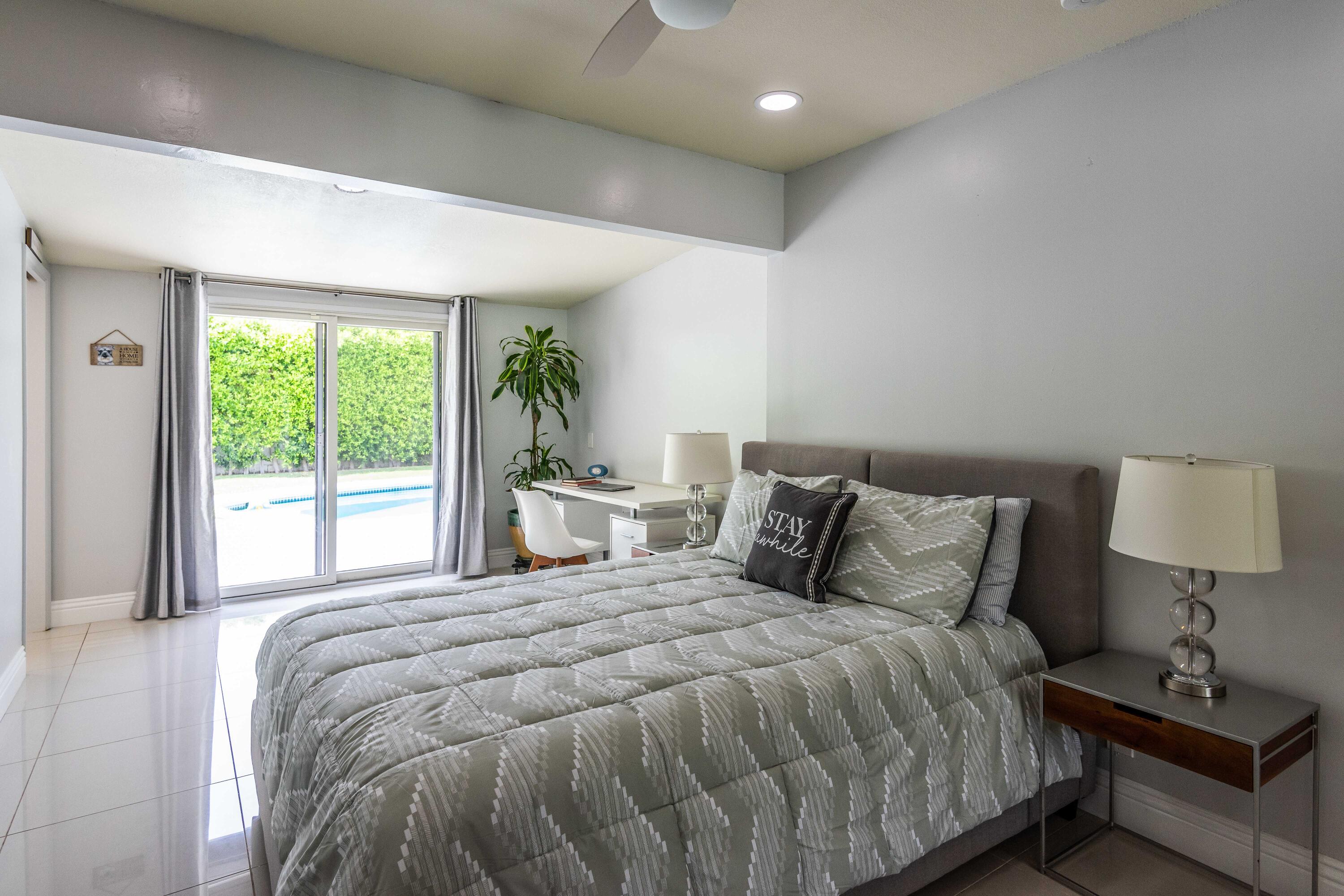 263 East Morongo Road Palm Springs, CA 92264 - Photo 15 of 29 a bedroom with a bed and a lamp